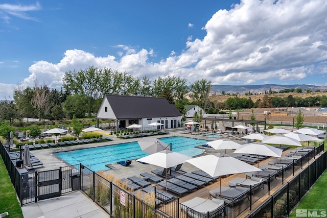 605 Braided Rope Dr, Reno, NV 89511 - community pool with fence, a patio, and a mountain view