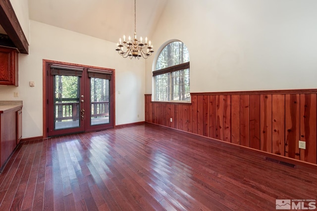 100 Timber Ln, Markleeville, CA 96120 - unfurnished dining area featuring a chandelier, dark wood-style flooring, french doors, wainscoting, and healthy amount of natural light