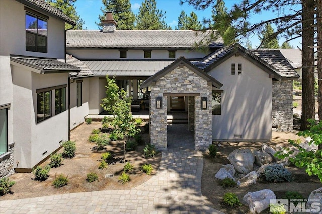 5192 Bordeaux Dr, Reno, NV 89511 - view of front of house featuring stucco siding, a chimney, and stone siding