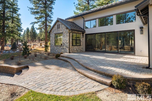 5192 Bordeaux Dr, Reno, NV 89511 - back of property featuring a patio area, stone siding, and stucco siding
