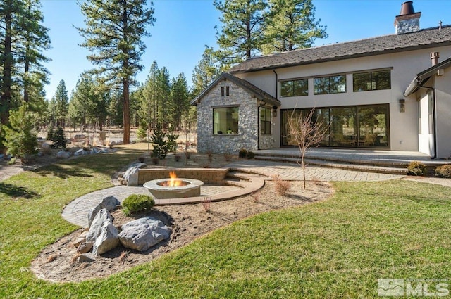 5192 Bordeaux Dr, Reno, NV 89511 - view of grassy yard featuring a fire pit and a patio