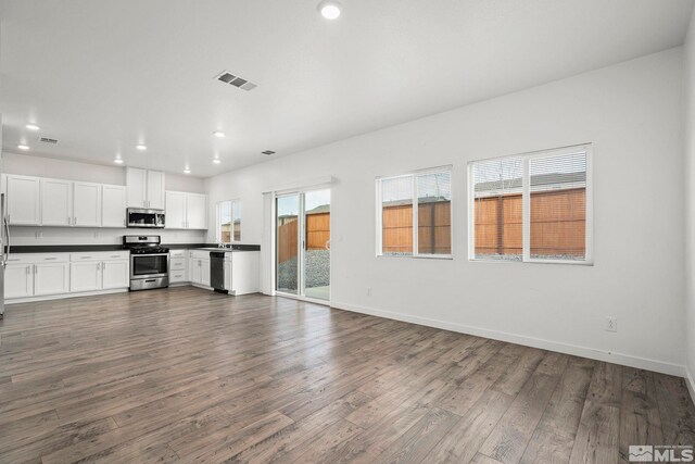 432 Summer Triangle, Reno, NV 89506 - unfurnished living room featuring dark wood-style flooring, recessed lighting, and baseboards