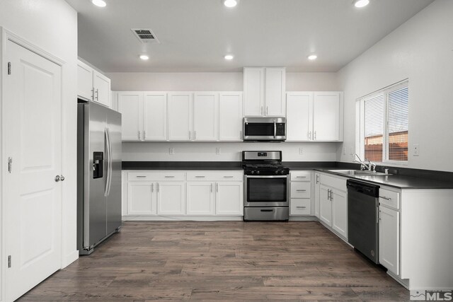 432 Summer Triangle, Reno, NV 89506 - kitchen with stainless steel appliances, dark countertops, a sink, white cabinetry, and recessed lighting