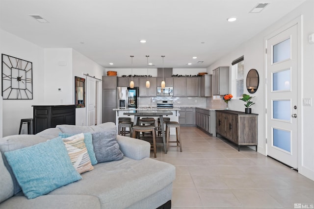 3617 Pulsar Ln Unit 2, Carson City, NV 89705 - living room with light tile patterned floors, a barn door, and recessed lighting