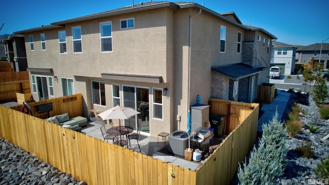 3617 Pulsar Ln Unit 2, Carson City, NV 89705 - back of property featuring stucco siding, a fenced backyard, a patio, and cooling unit