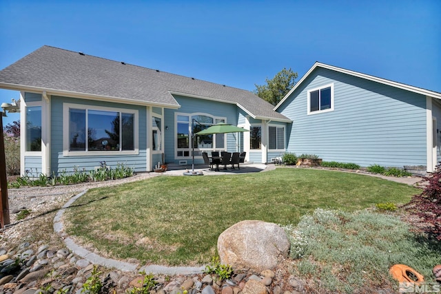 1655 Chiquita Cir, Minden, NV 89423 - rear view of property featuring a patio area, a yard, and a shingled roof