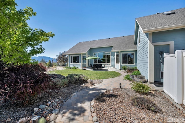 1655 Chiquita Cir, Minden, NV 89423 - back of property featuring a patio area, roof with shingles, a lawn, and a mountain view