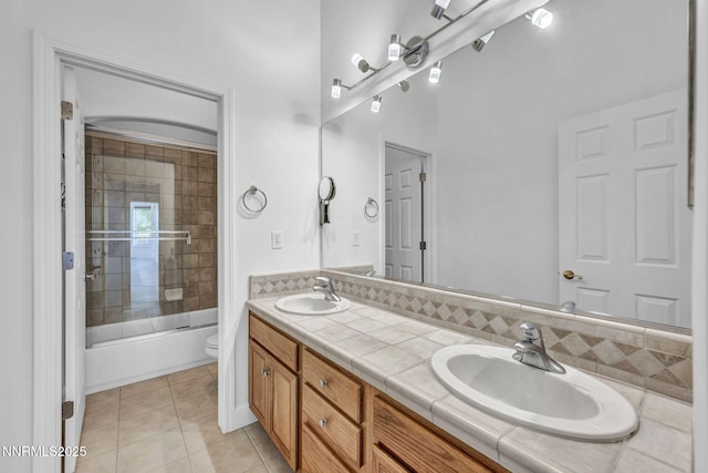 1655 Chiquita Cir, Minden, NV 89423 - full bath with double vanity, toilet, tile patterned flooring, enclosed tub / shower combo, and decorative backsplash