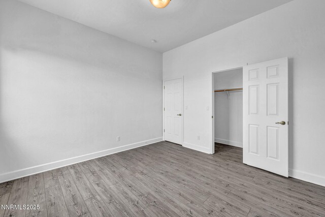 1655 Chiquita Cir, Minden, NV 89423 - unfurnished bedroom featuring baseboards, wood finished floors, and a closet