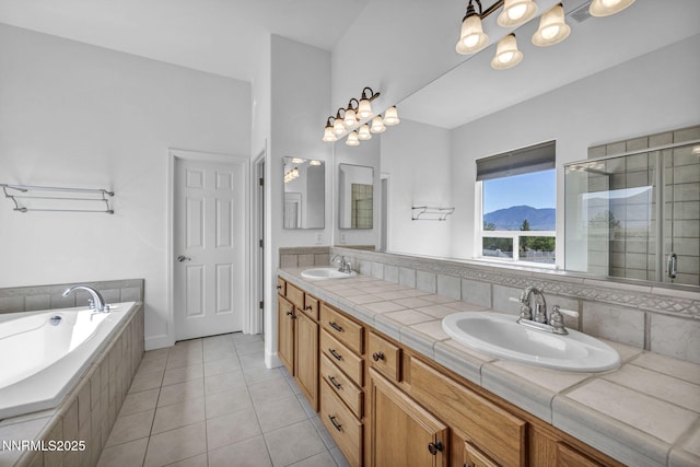 1655 Chiquita Cir, Minden, NV 89423 - full bathroom with double vanity, tile patterned floors, a garden tub, a stall shower, and a chandelier
