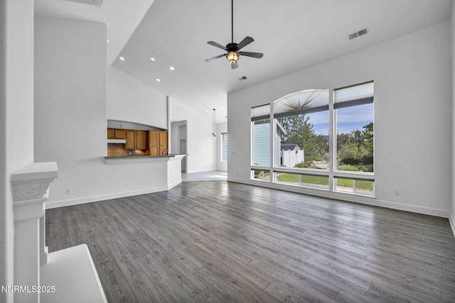 1655 Chiquita Cir, Minden, NV 89423 - unfurnished living room with high vaulted ceiling, dark wood-style floors, a ceiling fan, baseboards, and recessed lighting