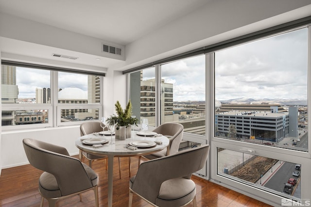 255 N Sierra St Unit 1011, Reno, NV 89501 - dining space featuring a view of city, plenty of natural light, and hardwood / wood-style floors