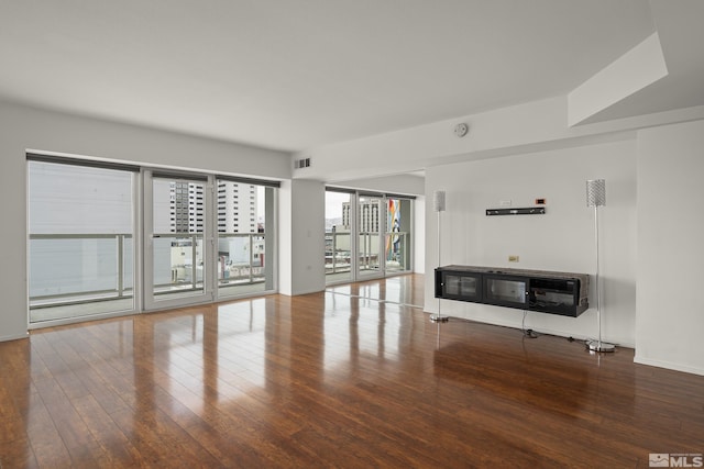 255 N Sierra St Unit 1011, Reno, NV 89501 - unfurnished living room with hardwood / wood-style floors and baseboards