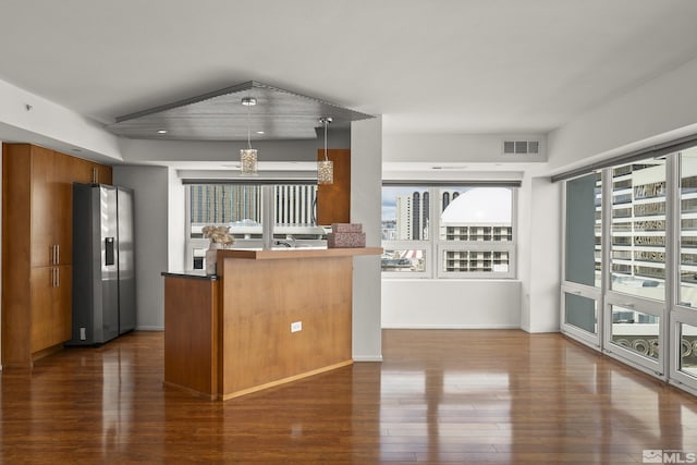 255 N Sierra St Unit 1011, Reno, NV 89501 - kitchen with stainless steel refrigerator with ice dispenser, dark wood-style floors, healthy amount of natural light, and brown cabinetry