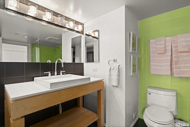 255 N Sierra St Unit 1011, Reno, NV 89501 - full bathroom with tile walls, toilet, a shower, tasteful backsplash, and vanity