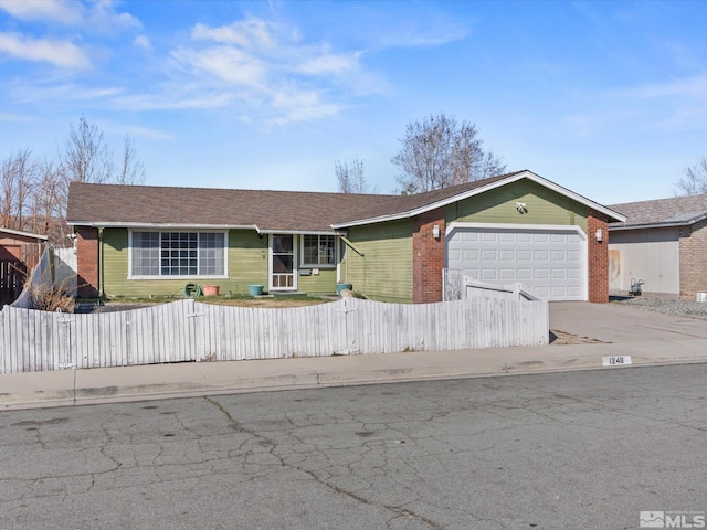 1248 Lindsay Ln, Carson City, NV 89706 - ranch-style house with a fenced front yard, a garage, driveway, and brick siding
