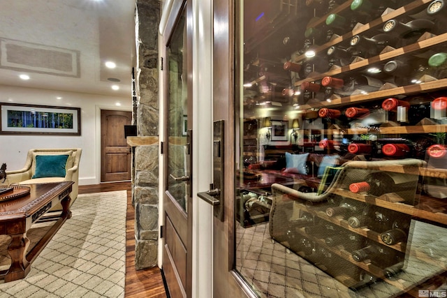 wine room with wood finished floors and recessed lighting