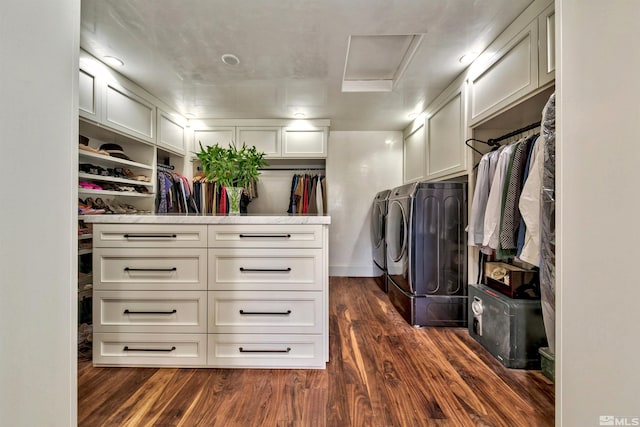 walk in closet featuring separate washer and dryer, dark wood-type flooring, and attic access
