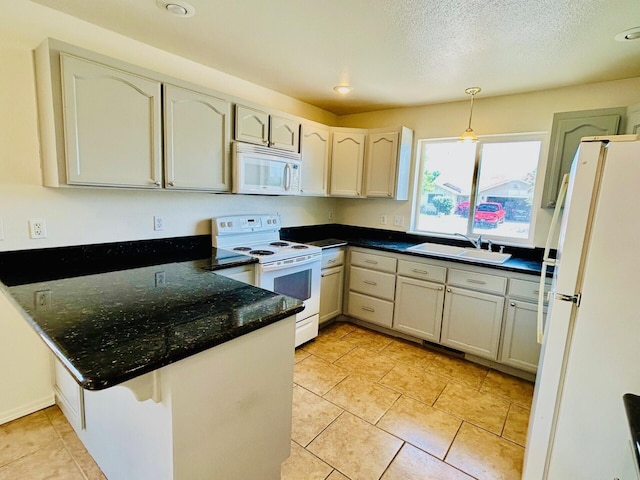 489 Torrey Pines Dr, Fallon, NV 89406 - kitchen with white appliances, a sink, a peninsula, light tile patterned flooring, and pendant lighting