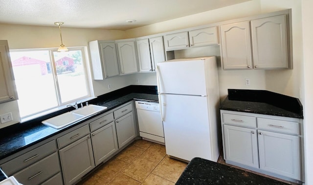 489 Torrey Pines Dr, Fallon, NV 89406 - kitchen featuring white appliances, a sink, dark countertops, hanging light fixtures, and white cabinetry