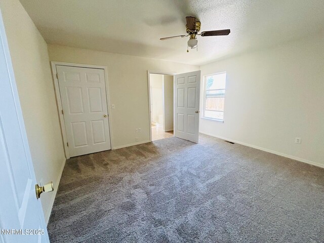489 Torrey Pines Dr, Fallon, NV 89406 - unfurnished bedroom with carpet floors, baseboards, and a ceiling fan