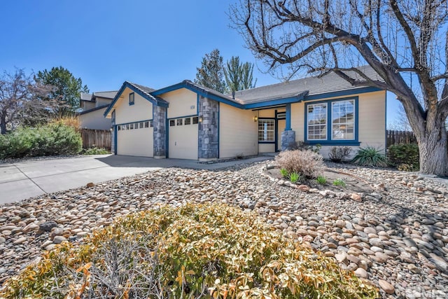 1675 Crestside Ct, Sparks, NV 89436 - ranch-style home with an attached garage, fence, concrete driveway, and stone siding