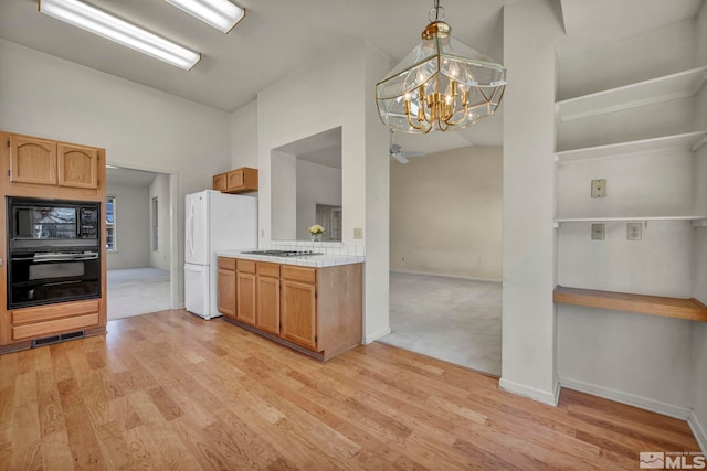1675 Crestside Ct, Sparks, NV 89436 - kitchen featuring black appliances, light countertops, vaulted ceiling, a chandelier, and light wood-style floors