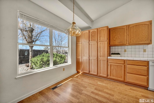 1675 Crestside Ct, Sparks, NV 89436 - unfurnished dining area featuring lofted ceiling, a chandelier, light wood finished floors, healthy amount of natural light, and baseboards