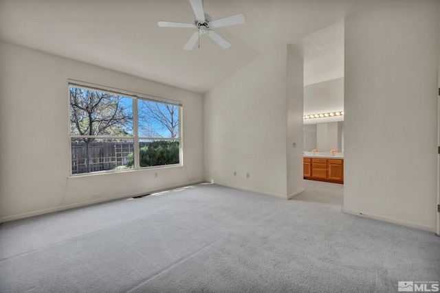 1675 Crestside Ct, Sparks, NV 89436 - unfurnished bedroom featuring light colored carpet, baseboards, connected bathroom, high vaulted ceiling, and a ceiling fan