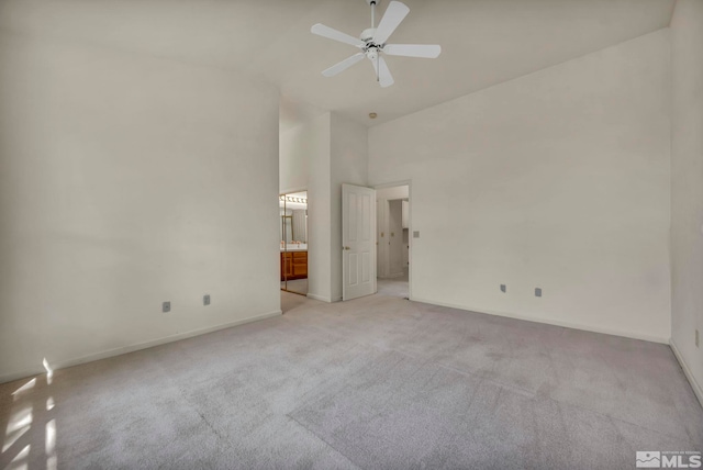 1675 Crestside Ct, Sparks, NV 89436 - unfurnished bedroom featuring light carpet, high vaulted ceiling, baseboards, ensuite bathroom, and a ceiling fan