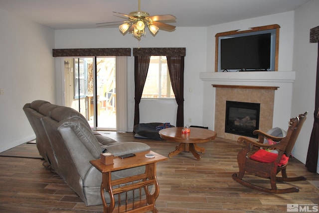 1075 Aster Ln, Fernley, NV 89408 - living area with ceiling fan, wood finished floors, plenty of natural light, and a fireplace