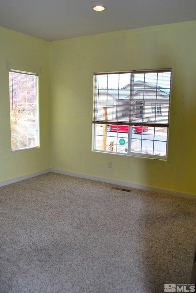 1075 Aster Ln, Fernley, NV 89408 - carpeted spare room featuring healthy amount of natural light, baseboards, and recessed lighting