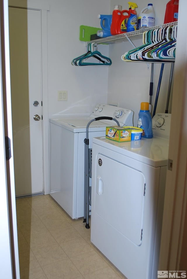 1075 Aster Ln, Fernley, NV 89408 - laundry room with washer and clothes dryer and light tile patterned flooring