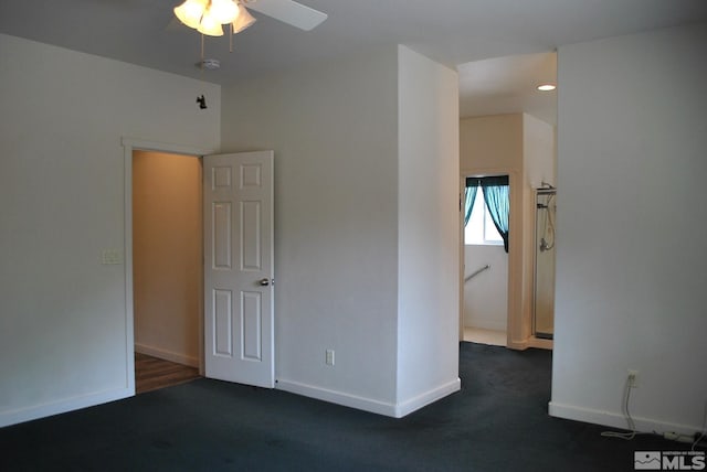 1075 Aster Ln, Fernley, NV 89408 - empty room featuring a ceiling fan, dark colored carpet, baseboards, and a smoke detector