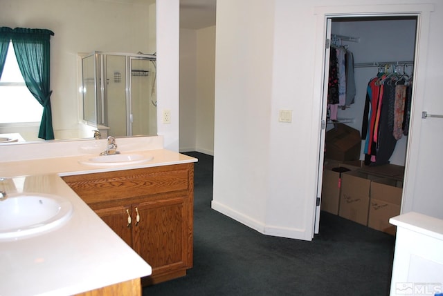 1075 Aster Ln, Fernley, NV 89408 - full bathroom with a shower stall, a walk in closet, and vanity