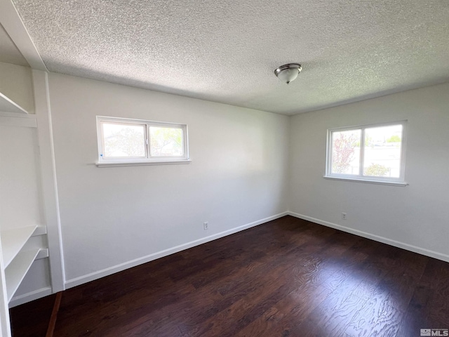 655 Gault Way, Sparks, NV 89431 - spare room featuring dark wood-style flooring, a textured ceiling, and baseboards