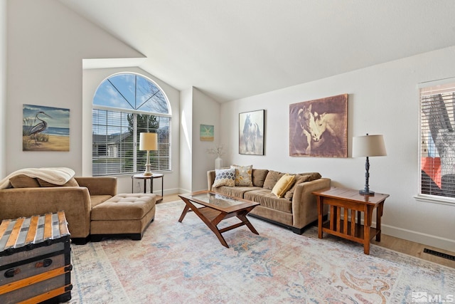 1673 Lantana Dr, Minden, NV 89423 - living area featuring vaulted ceiling, wood finished floors, baseboards, and healthy amount of natural light