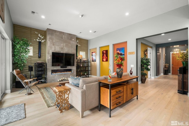 9179 Graycliff Ln, Reno, NV 89523 - living room featuring a tile fireplace, light wood-style floors, recessed lighting, and baseboards