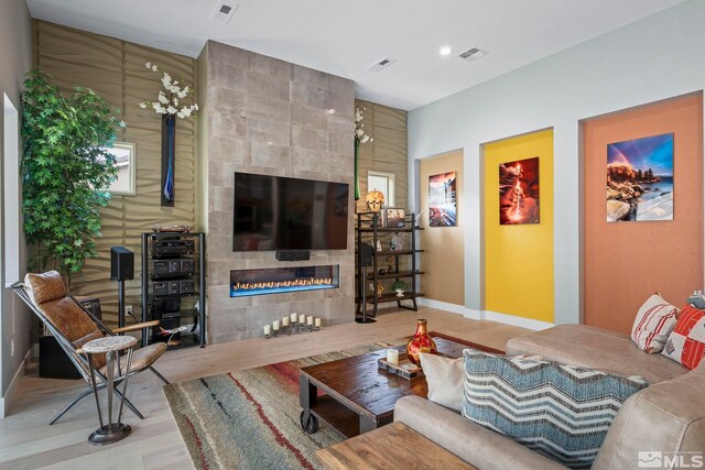 9179 Graycliff Ln, Reno, NV 89523 - living area featuring wood finished floors, a tile fireplace, baseboards, and recessed lighting