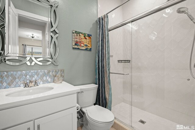 9179 Graycliff Ln, Reno, NV 89523 - bathroom featuring a stall shower, a textured wall, toilet, and vanity
