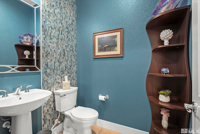 9179 Graycliff Ln, Reno, NV 89523 - half bath featuring toilet, baseboards, and a sink