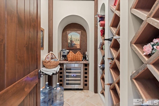 wine room with beverage cooler and a dry bar