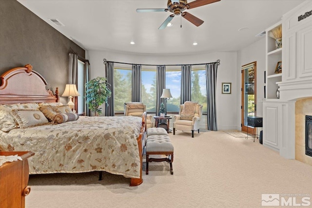 bedroom featuring access to outside, a fireplace, carpet, recessed lighting, and ceiling fan