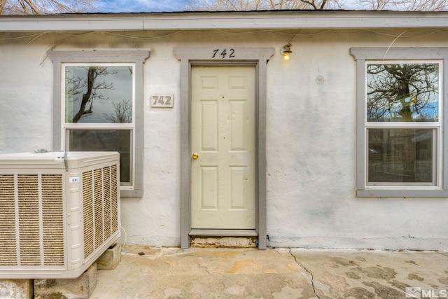 742 D St, Hawthorne, NV 89415 - property entrance featuring central AC and stucco siding
