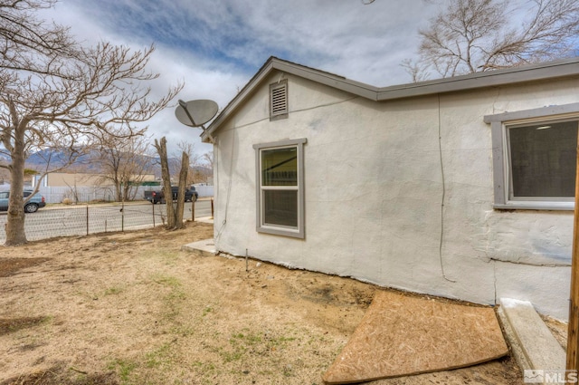 742 D St, Hawthorne, NV 89415 - view of home's exterior featuring stucco siding and fence