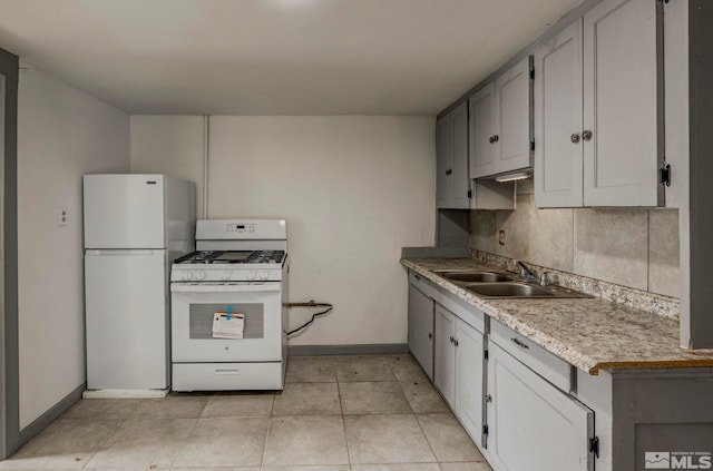 742 D St, Hawthorne, NV 89415 - kitchen featuring white appliances, a sink, baseboards, light countertops, and light tile patterned floors