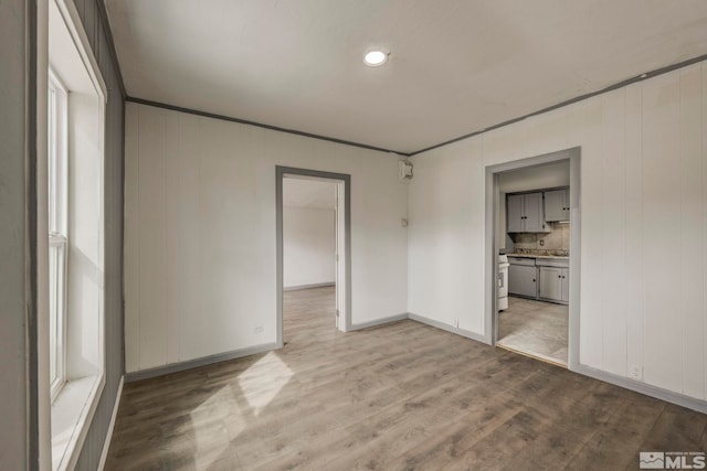 742 D St, Hawthorne, NV 89415 - unfurnished bedroom with wood finished floors, baseboards, and ensuite bath