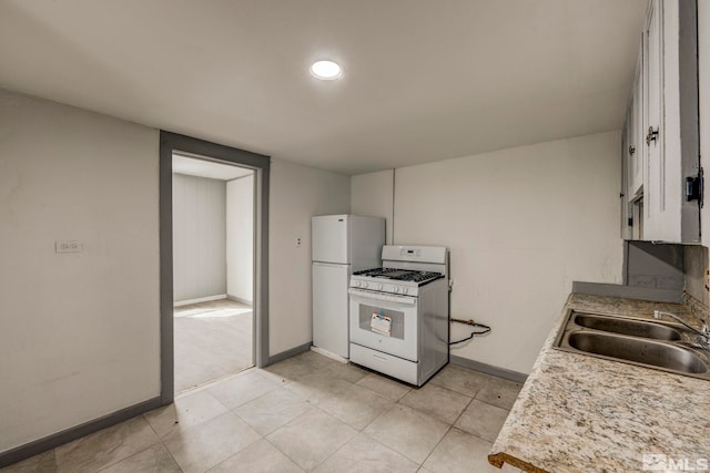 742 D St, Hawthorne, NV 89415 - kitchen with white appliances, a sink, light countertops, and baseboards
