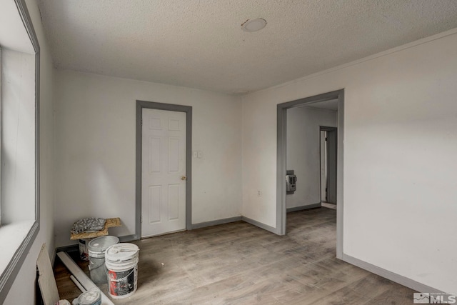 742 D St, Hawthorne, NV 89415 - empty room featuring a textured ceiling, light wood-style floors, and baseboards