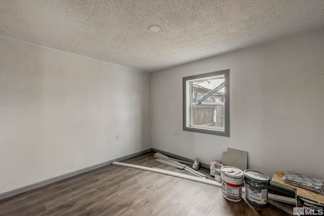 742 D St, Hawthorne, NV 89415 - unfurnished room with wood finished floors, a textured ceiling, and baseboards